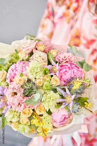 Beautiful bouquet of mixed flowers in woman hand. Floral shop concept . Handsome fresh bouquet. Flowers delivery.