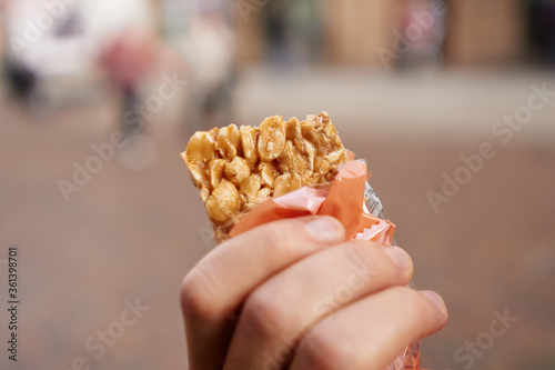 Honey bars with peanuts in the hand. Sweet candy snack