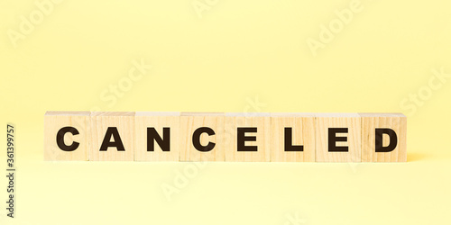 word canceled made with small wooden cubes on yellow