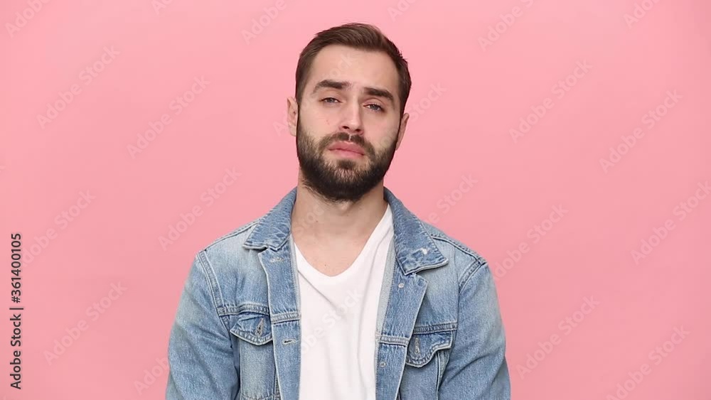Tired bearded young man guy 20s years old in denim jacket white t-shirt isolated on pastel pink background studio. People lifestyle concept. Looking camera yawning want to sleep cover mouth with hand Tired bearded young man guy 20s years old in denim jacket white t-shirt isolated on pastel pink background studio. People lifestyle concept. Looking camera yawning want to sleep cover mouth with hand