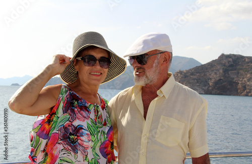   Happy couple of seniors on the tourist boat  smiling, enjoying trip on the Mediterranian sea