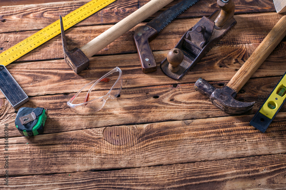 carpenter tools on wood table background