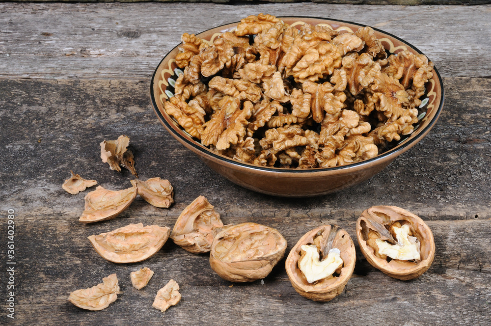 Fototapeta premium Peeled nuts in a bowl. Front view.
