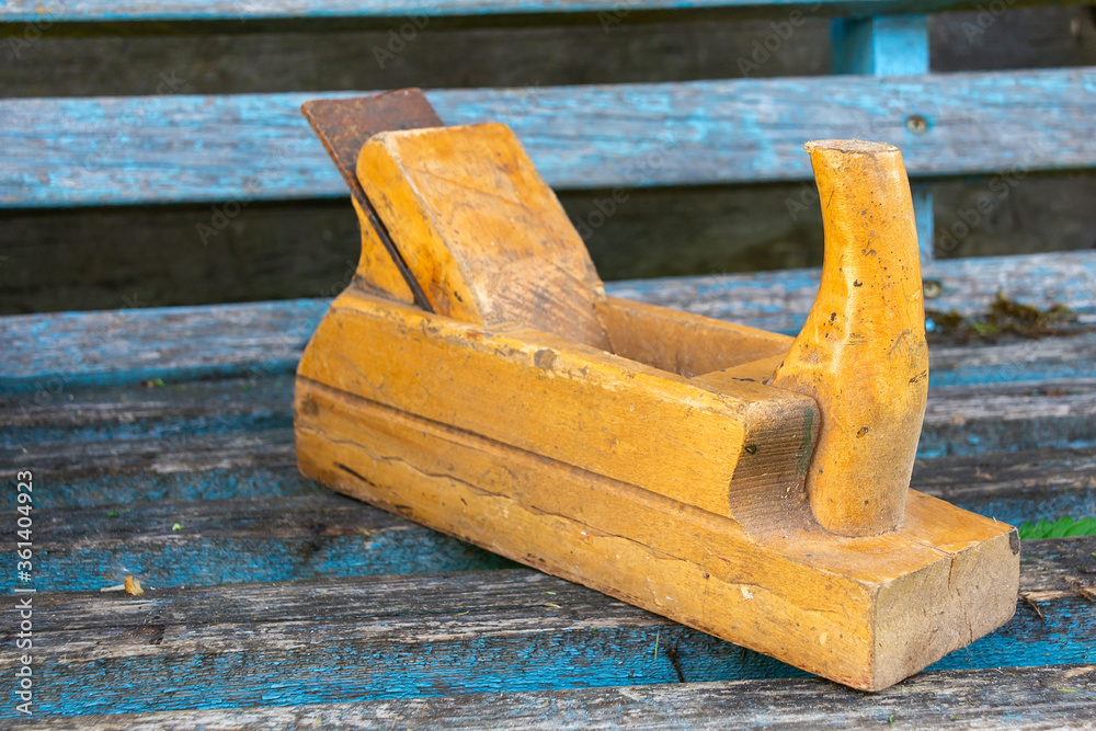Old wooden jointer on old wooden boards. The concept of wood processing and manual work. Old wooden jointer on old wooden boards. The concept of wood processing and manual work.