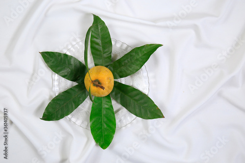 Wallpaper Mural Fresh tasty eggfruit decorated with leaves on a glass bowl Torontodigital.ca