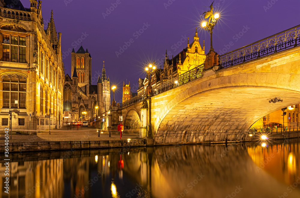 Φωτογραφία The Saint Michael Bridge and the belfry tower of Gent (Ghent) with a reflection in the Leie river by the Graslei at night, East Flanders, Belgium