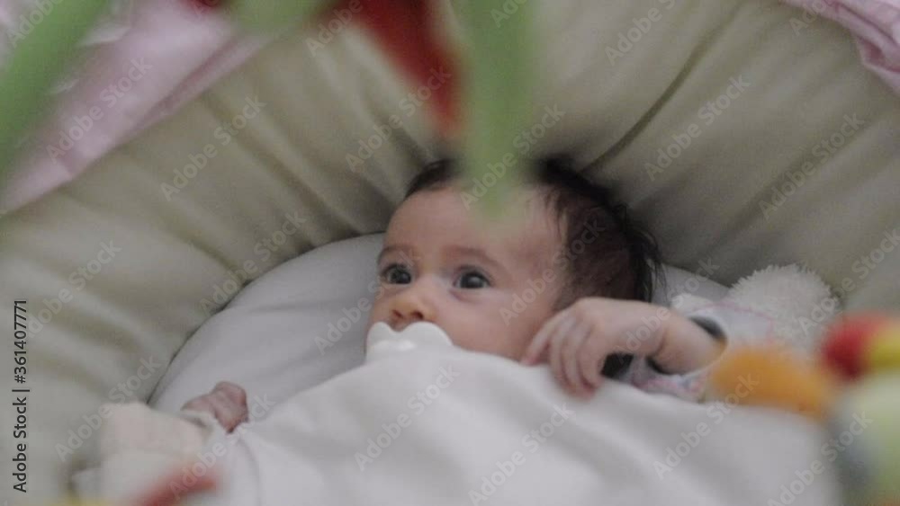 Sweetest baby girl with a colorful mobile toy Sweetest baby girl with a colorful mobile toy