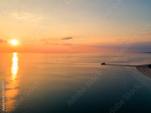 Aerial view of sunset over the sea in Palanga, Lithuania. Sandy coastline with the bridge to the sea.