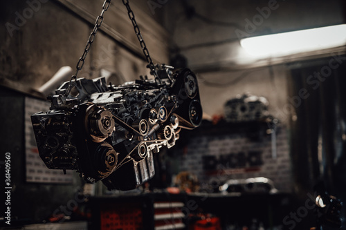 Konstfotografi Closeup view of a suspended boxer engine in a dark garage or workshop