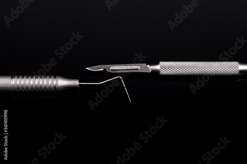 Closeup of professional dental tools. Periodontal probe and scalpel.