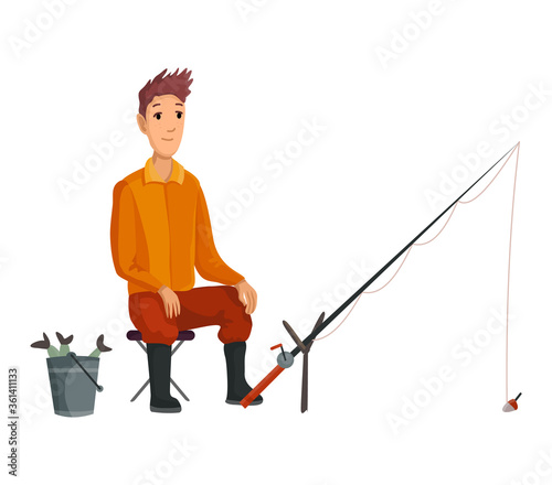 Young fisherman seating with fish rod and wait bite.Caughted fish in a bucket. Successful fishing