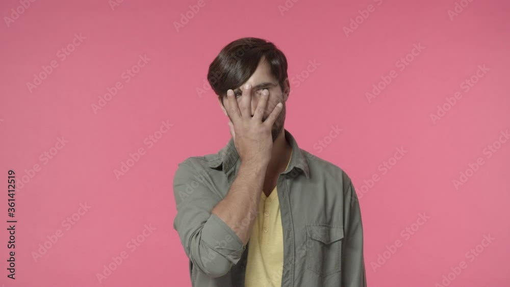 Oh god why me. Annoyed and bothered, distressed handsome man, facepalm, rolling eyes and sighing from irritation and tensed feelings, hate dealing with boring people, pink background Oh god why me. Annoyed and bothered, distressed handsome man, facepalm, rolling eyes and sighing from irritation and tensed feelings, hate dealing with boring people, pink background