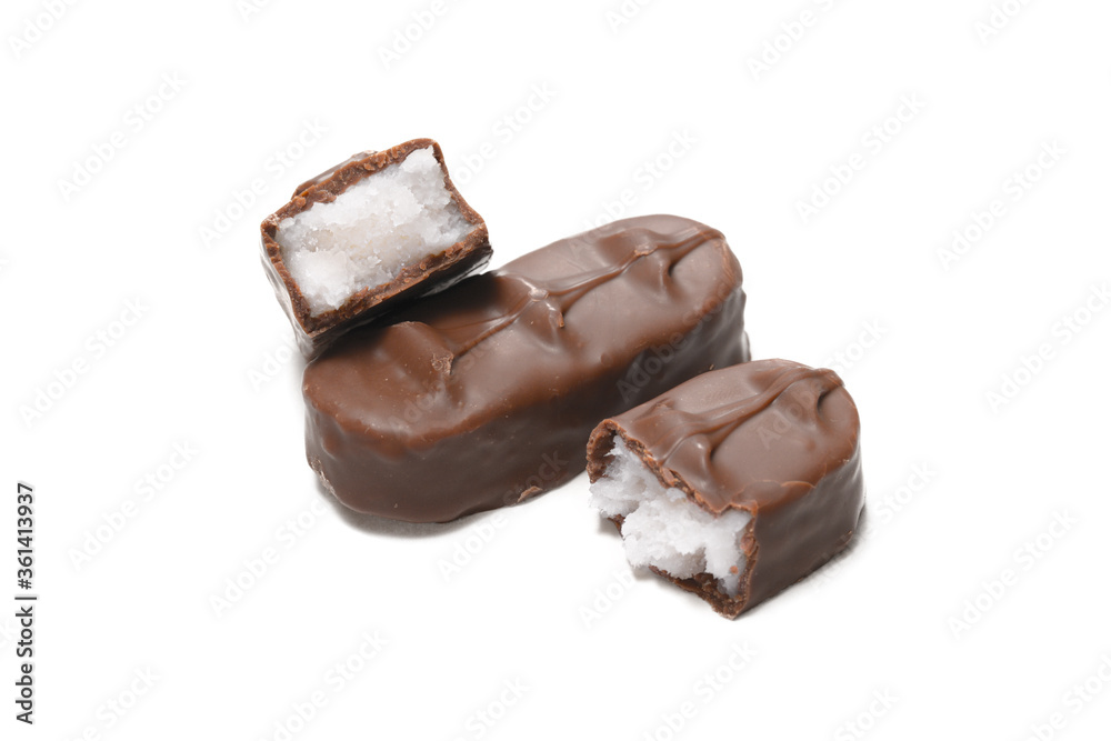 A slice of milk chocolate with coconut filling and broken in half A slice of milk chocolate with coconut filling and broken in half