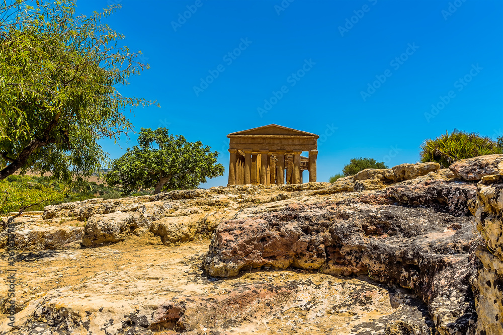 The Temple of Concordia viewed from a rocky outcrop in the ancient Sicilian city of Agrigento in summer