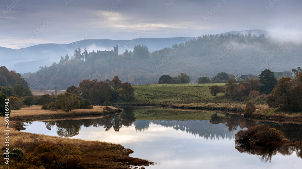 Misty Scottish Highlands Castle with  river reflections 