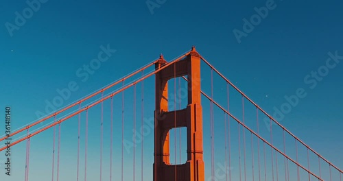 Birds flying around the top of one the Golden Gate Bridge tower in San Francisco