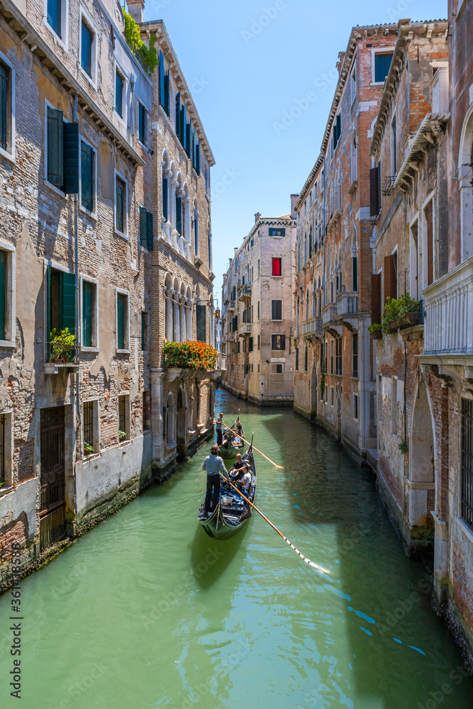 Classical picture of the venetian canals with gondola.