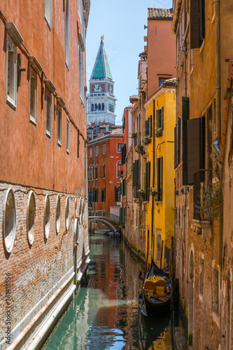 Classical picture of the venetian canals with gondola. photo