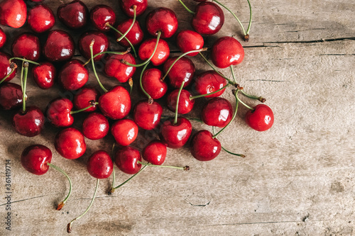Fresh ripe cherries on wooden background.Top view. Copy, empty space for text