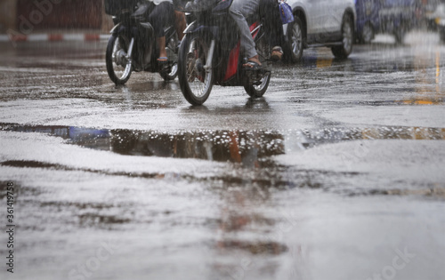 Cars and motorcycle during rush hour after hard rain fall .Selective focus.Selective focus and shallow depth of field composition.