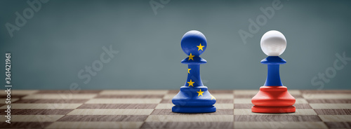 European Union and Russia conflict. Flags on chess pawns on a chess board. 
