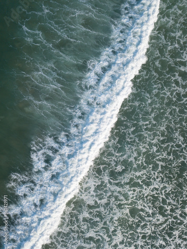 Aerial photo of waves breaking near a rural surf beach, New Zealand.  © Carl