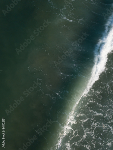 Aerial photo of waves breaking near a rural surf beach, New Zealand. 
