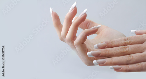 Fotografiet beautiful hands with manicured french nails manicure