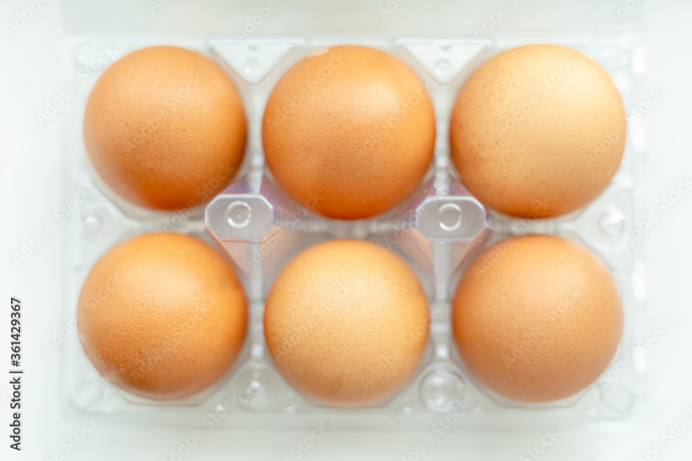 tray with chicken eggs on a light background, top view