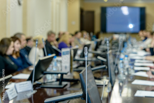 Business people work discussion concept, microphone in the foreground.