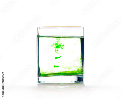 Green ink in water, color abstraction, color explosion in a glass.