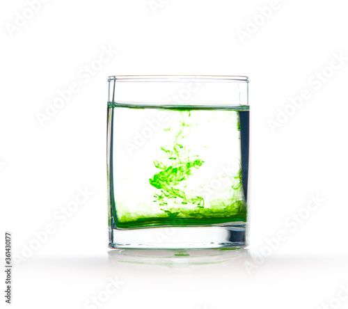 Green ink in water, color abstraction, color explosion in a glass.
