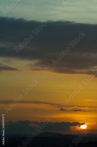 warm summer sunset with sun and clouds © sergio