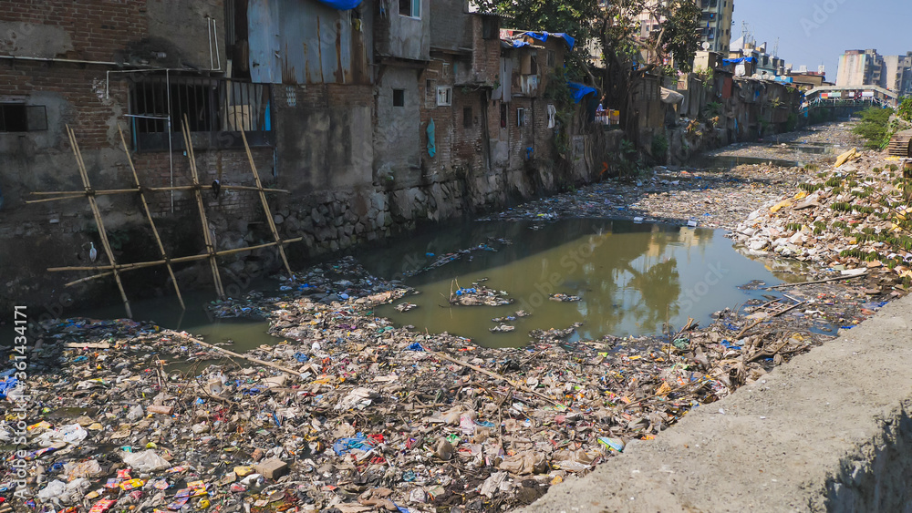 Dirty river in Dharavi slums. Mumbai. India. Foto Stok Adobe Stock