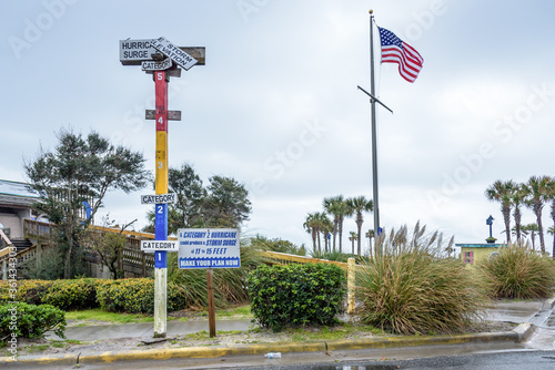 Wooden Funky Hurricane Storm Surge Meter at the Beach with an American Flag Flying Above