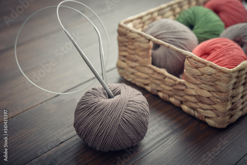 Colored yarn balls in rustic wicker basket