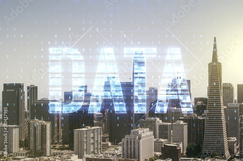 Data word hologram on San Francisco office buildings background, big data and blockchain concept. Multiexposure