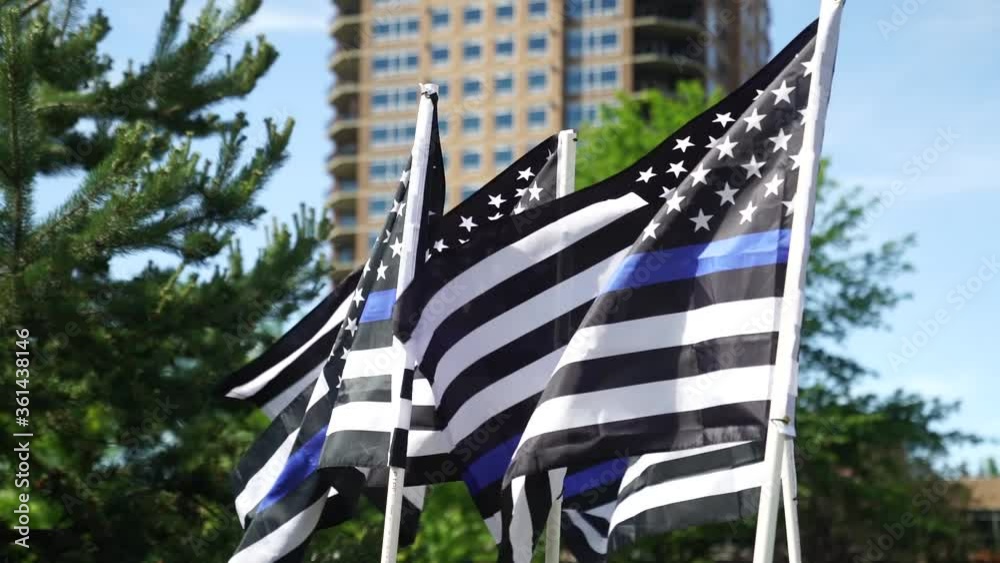 Blue lives matter flags blowing in wind high-rise background Stock ビデオ ...