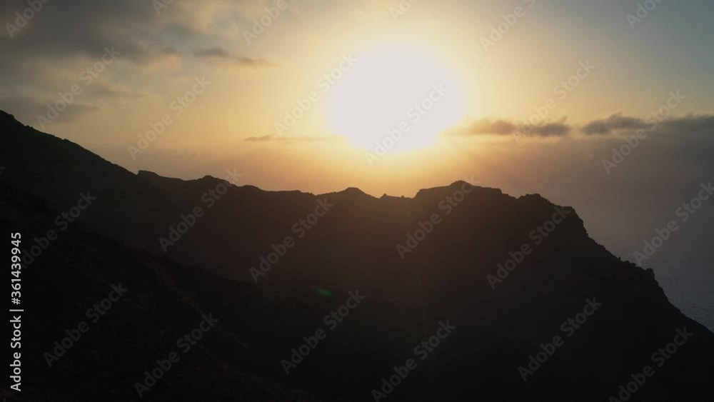 Climbers Standing At The Top Of A Mountain While Enjoying The Beautiful Sunrise In Las Palmas, Gran Canaria, Spain - tilt-up revealing shot Climbers Standing At The Top Of A Mountain While Enjoying The Beautiful Sunrise In Las Palmas, Gran Canaria, Spain - tilt-up revealing shot