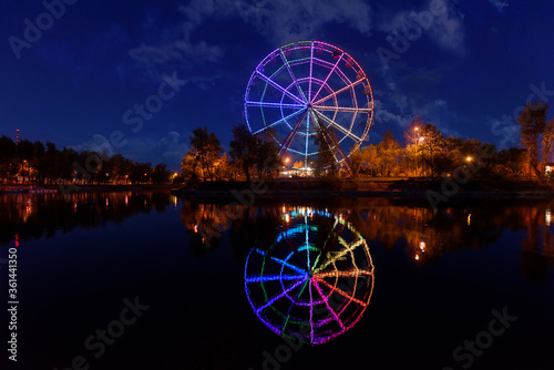 Colorfull abstract Ferris wheel with reflection on the Konny island in Irkutsk city