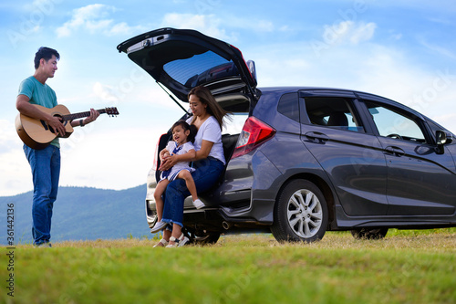 happy little girl with family sitting in the car.Car insurance concept