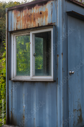 Abandoned rusted metal guardhouse