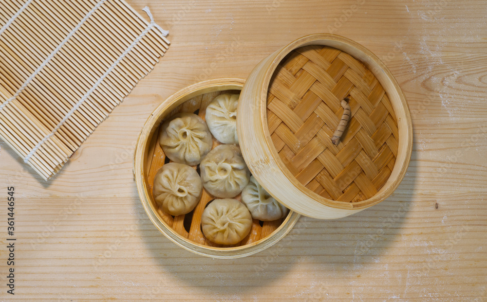 Fototapeta premium Top view of steamed buns in bamboo steamer, homemade Chinese traditional food