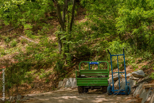 Green hand operated truck and blue dolly