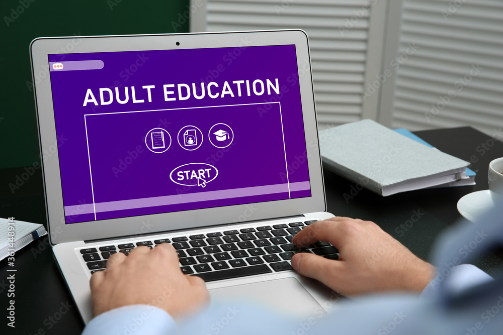 Man using laptop for online studying indoors, closeup. Adult education Man using laptop for online studying indoors, closeup. Adult education