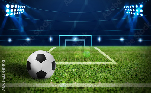 Soccer ball on green football field, space for text