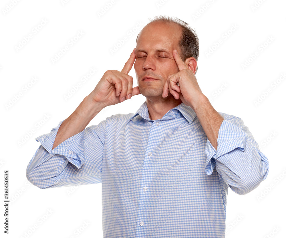Young relaxed peaceful businessman meditating at workplace to reduce stress