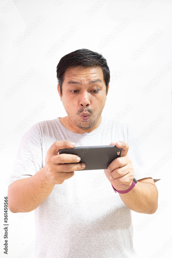 man was stunned while looking at the mobile phone man was stunned while looking at the mobile phone