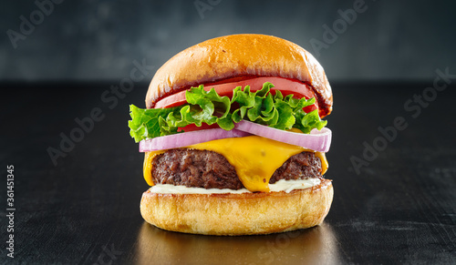 thick cheeseburger with american cheese, lettuce tomato and onion