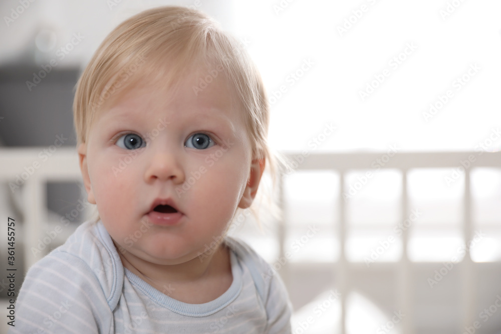 Adorable little baby on blurred background, closeup